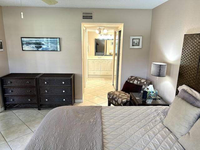 11231 Green Lake Dr Unit 104, Boynton Beach, FL 33437 - bedroom featuring tile patterned flooring, a chandelier, and connected bathroom