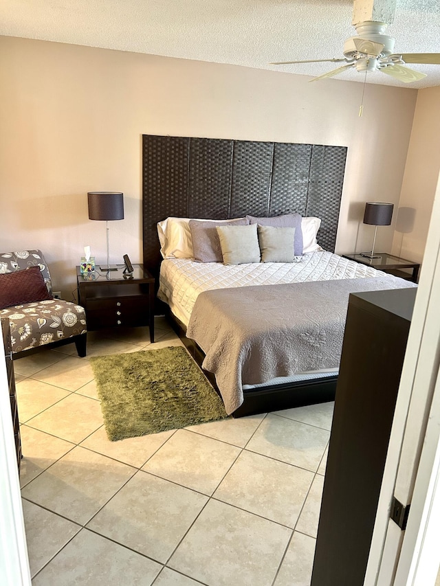 11231 Green Lake Dr Unit 104, Boynton Beach, FL 33437 - tiled bedroom featuring ceiling fan and a textured ceiling