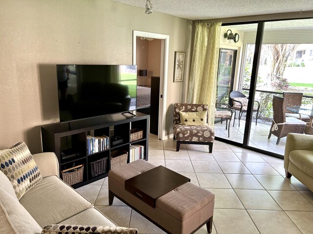 11231 Green Lake Dr Unit 104, Boynton Beach, FL 33437 - living area with a textured wall, light tile patterned floors, and a textured ceiling