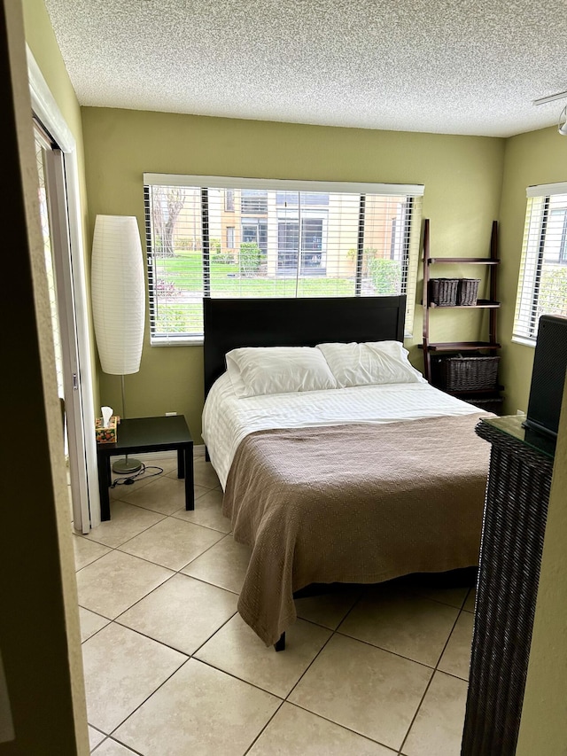 11231 Green Lake Dr Unit 104, Boynton Beach, FL 33437 - bedroom with light tile patterned floors and a textured ceiling