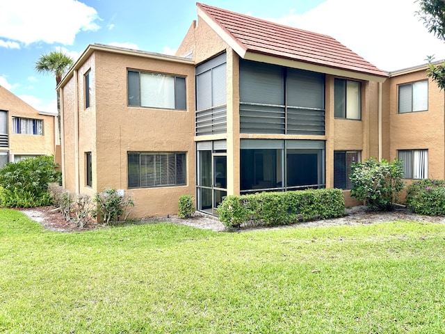 11231 Green Lake Dr Unit 104, Boynton Beach, FL 33437 - back of house with stucco siding and a lawn