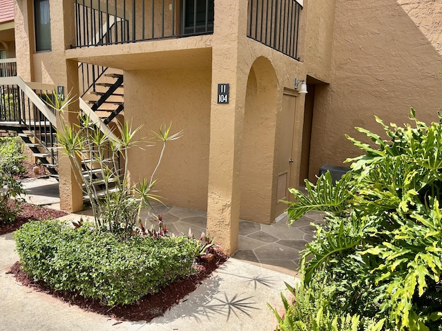 11231 Green Lake Dr Unit 104, Boynton Beach, FL 33437 - entrance to property with stucco siding and a balcony