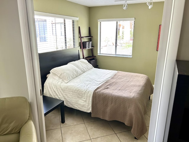 11231 Green Lake Dr Unit 104, Boynton Beach, FL 33437 - bedroom with track lighting and light tile patterned floors