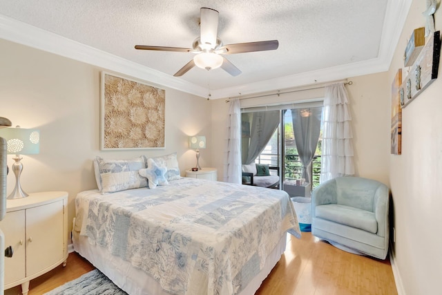 bedroom with access to outside, a textured ceiling, ornamental molding, light wood-type flooring, and ceiling fan