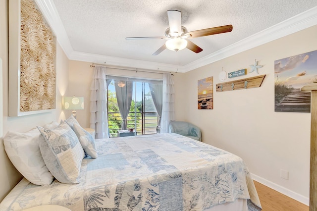 bedroom featuring a textured ceiling, ornamental molding, wood finished floors, access to outside, and a ceiling fan