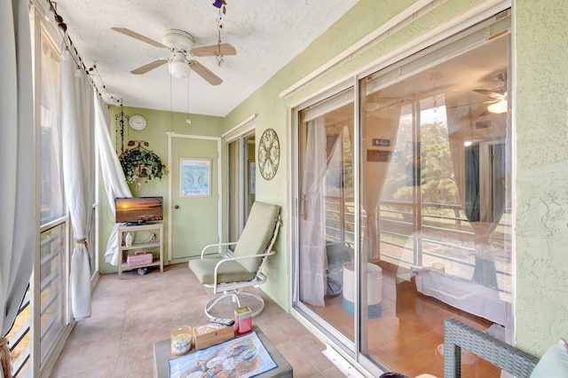 sunroom featuring ceiling fan