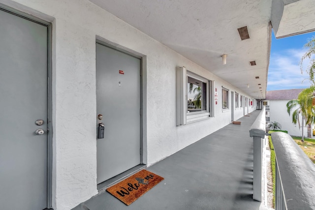 view of exterior entry with stucco siding