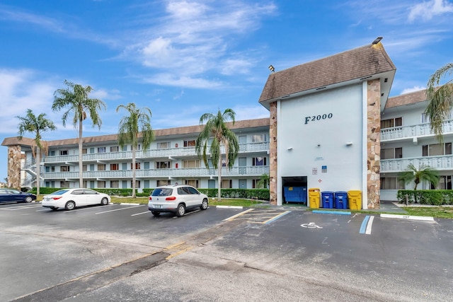 view of apartment building / complex with uncovered parking