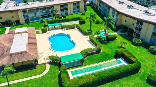 aerial view of property and surrounding area featuring a pool