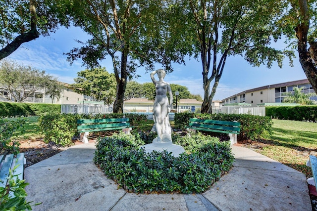 view of home's community featuring fence