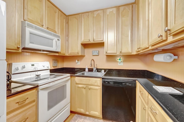 kitchen featuring white appliances, a sink, and light brown cabinets
