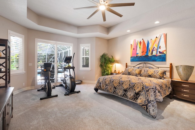 carpeted bedroom featuring baseboards, a ceiling fan, recessed lighting, a raised ceiling, and an office area