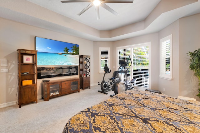bedroom featuring light carpet, baseboards, and a ceiling fan
