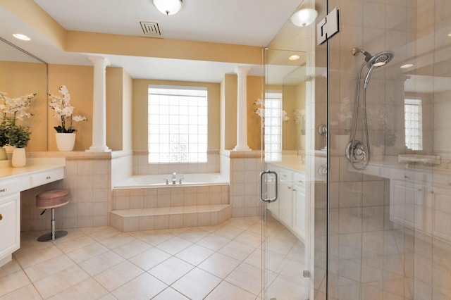 full bath with ornate columns, a garden tub, tile patterned floors, a stall shower, and tile walls