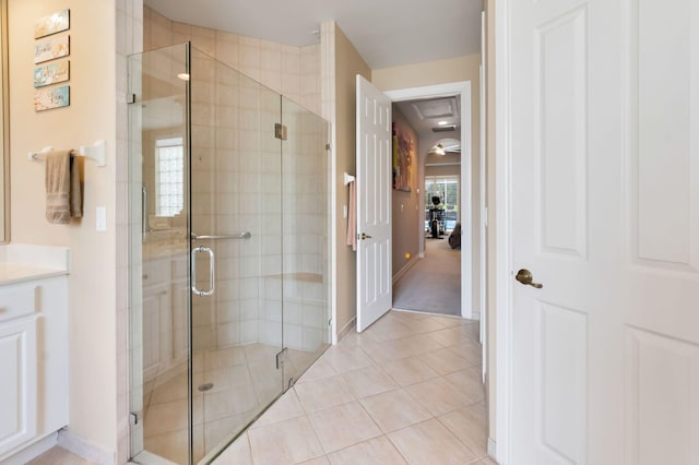 bathroom with a shower stall, tile patterned flooring, vanity, and baseboards