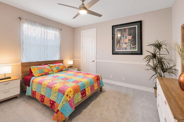 carpeted bedroom with a ceiling fan and baseboards