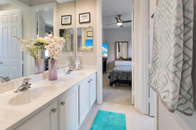 ensuite bathroom with tile patterned floors, double vanity, and ceiling fan