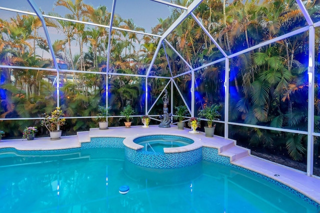 view of pool featuring a lanai and a pool with connected hot tub