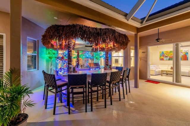 bar with concrete flooring and a ceiling fan