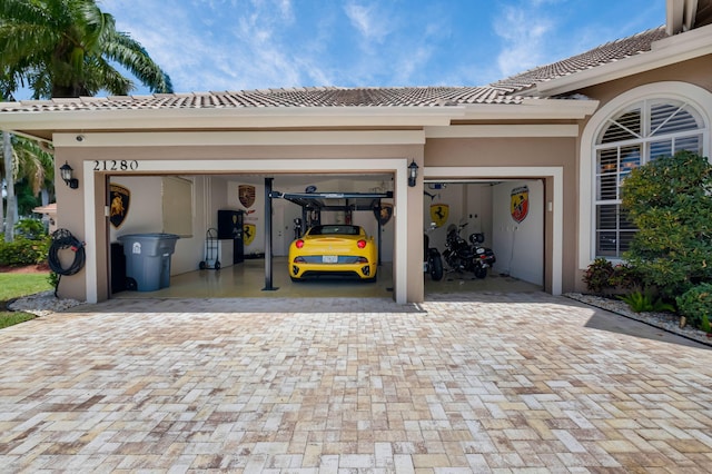 garage featuring decorative driveway