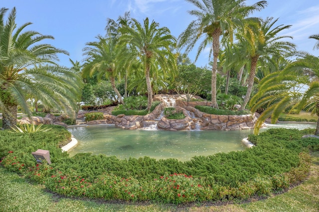 view of community with a garden pond