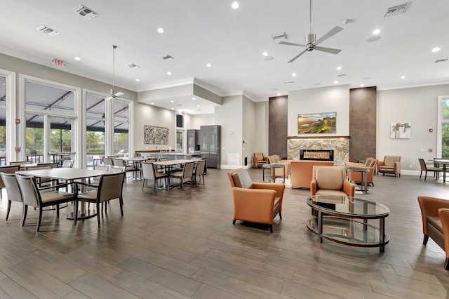 common area with ornamental molding and recessed lighting