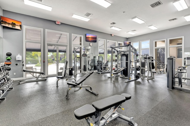 gym with french doors and baseboards