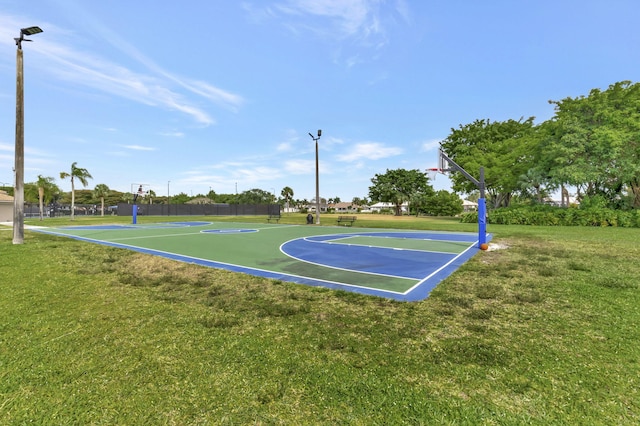 view of basketball court with community basketball court and a lawn