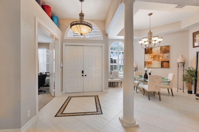entryway featuring a chandelier, baseboards, and light tile patterned floors