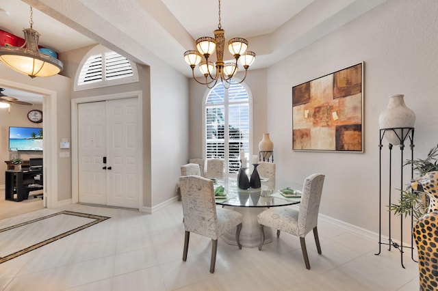 dining space with a chandelier and baseboards