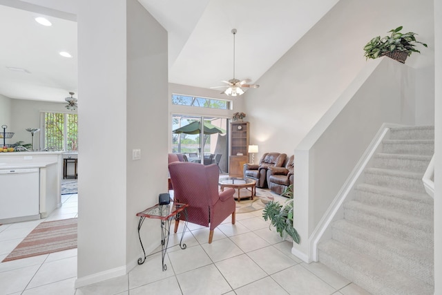living area with ceiling fan, stairway, light tile patterned flooring, recessed lighting, and baseboards