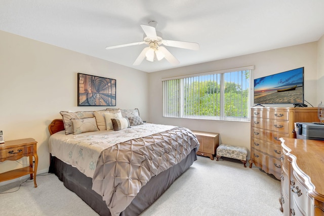 bedroom with light carpet and a ceiling fan