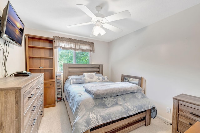 bedroom with light carpet and a ceiling fan