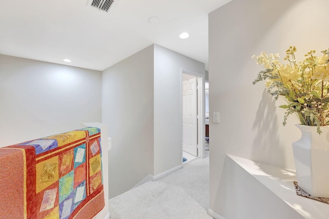 hallway featuring light carpet, recessed lighting, and baseboards