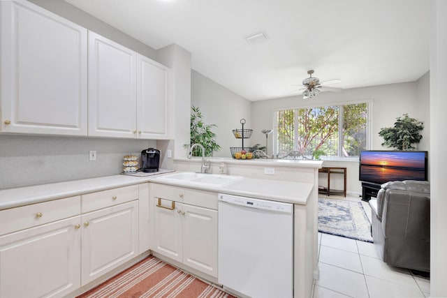 kitchen with white dishwasher, a sink, a peninsula, ceiling fan, and white cabinets