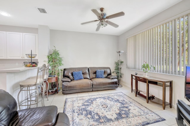living room with light tile patterned floors and a ceiling fan