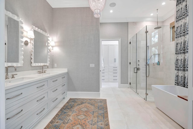 bathroom featuring a stall shower, double vanity, a freestanding bath, ornamental molding, and baseboards