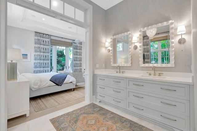 bathroom with connected bathroom, double vanity, and tile patterned flooring