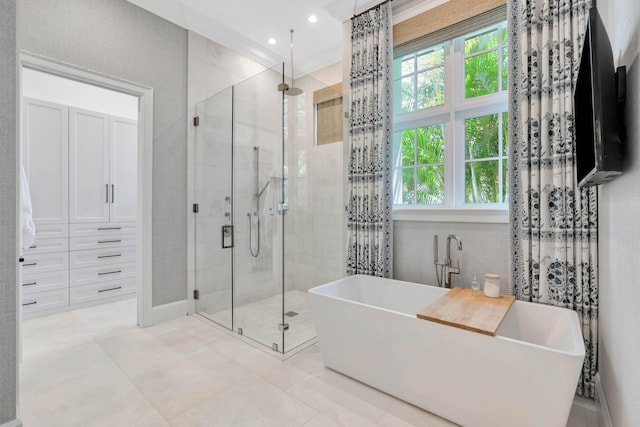 bathroom featuring a stall shower, plenty of natural light, a soaking tub, and tile patterned floors