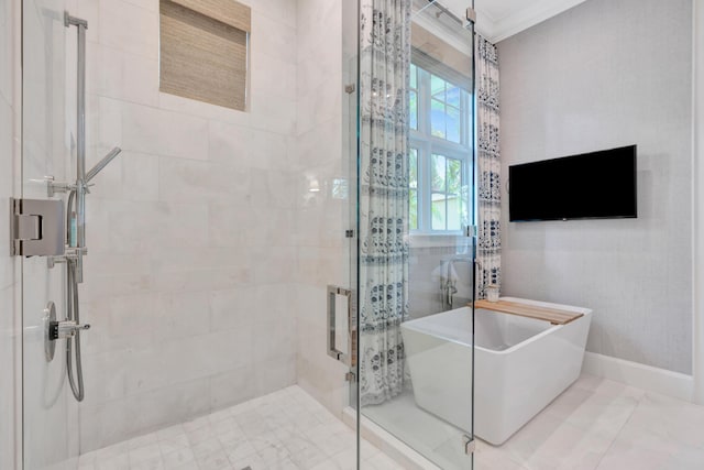 bathroom with a soaking tub, a stall shower, and ornamental molding
