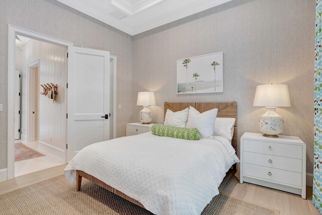 bedroom with crown molding and wood finished floors