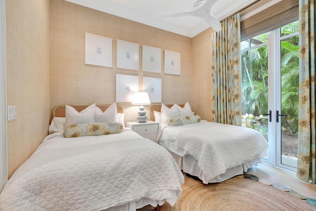 bedroom with access to exterior, ornamental molding, and wood finished floors