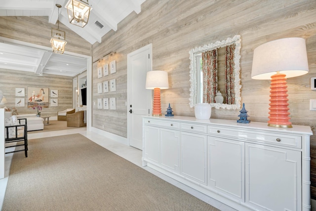hallway with wooden walls and a chandelier