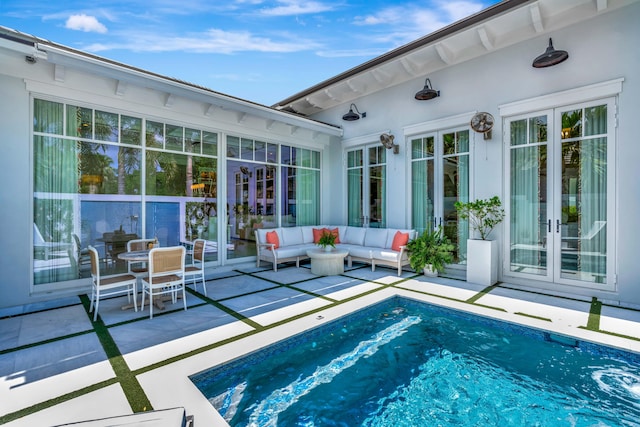outdoor pool featuring french doors, a patio area, and outdoor lounge area