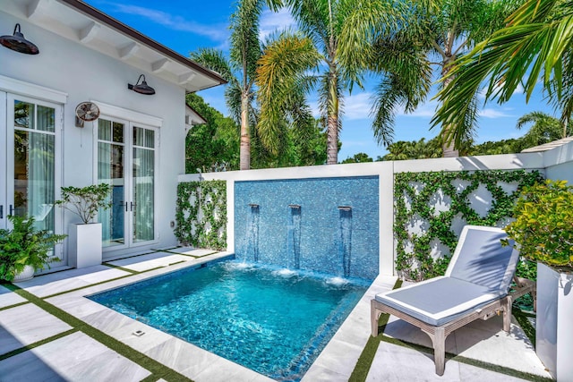 view of pool featuring french doors