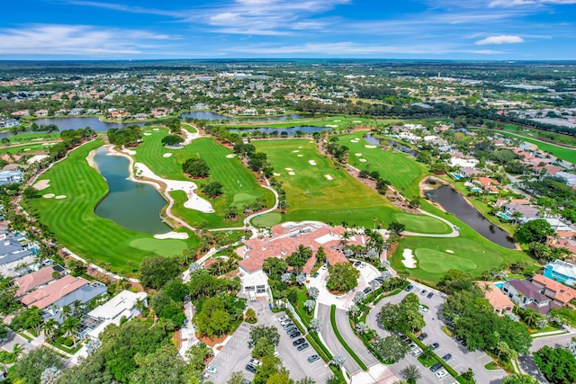view of property location with a local golf course, a large body of water, and nearby suburban area