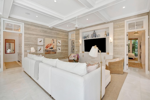 living area featuring crown molding, wooden walls, beam ceiling, coffered ceiling, and a ceiling fan