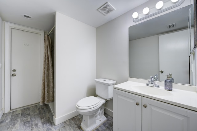 full bathroom with toilet, vanity, a shower with curtain, wood finished floors, and baseboards
