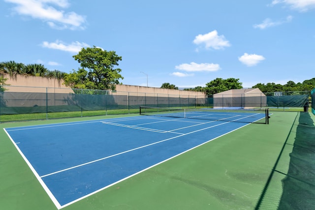 view of tennis court with fence and community basketball court