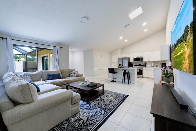 living area with light tile patterned floors, baseboards, recessed lighting, and high vaulted ceiling